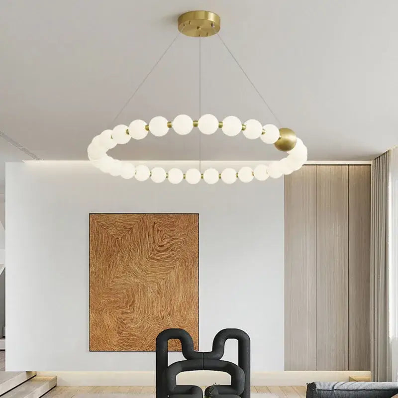 Spiral brass led chandelier with a gold-toned metal frame and frosted acrylic spheres by decorbites brass led decor