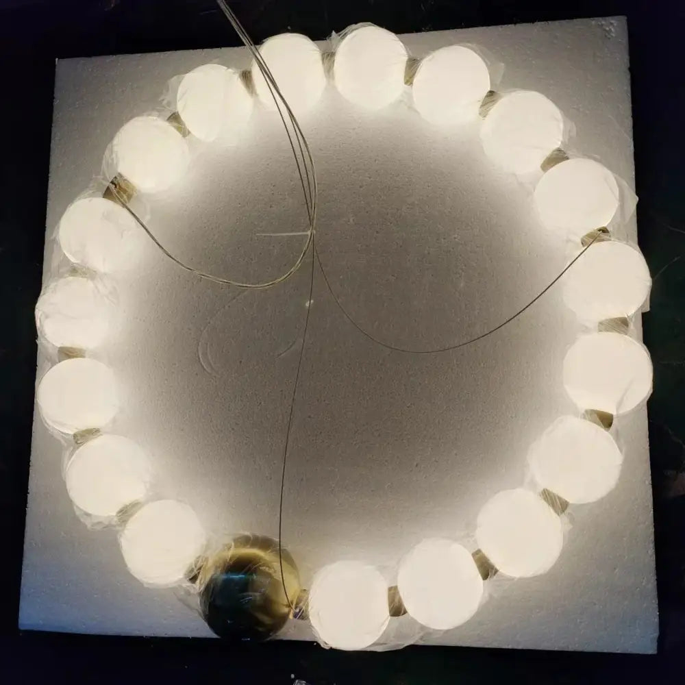 Spiral brass led chandelier with glowing white spherical bulbs encased in clear plastic for dining room decorbites brass led