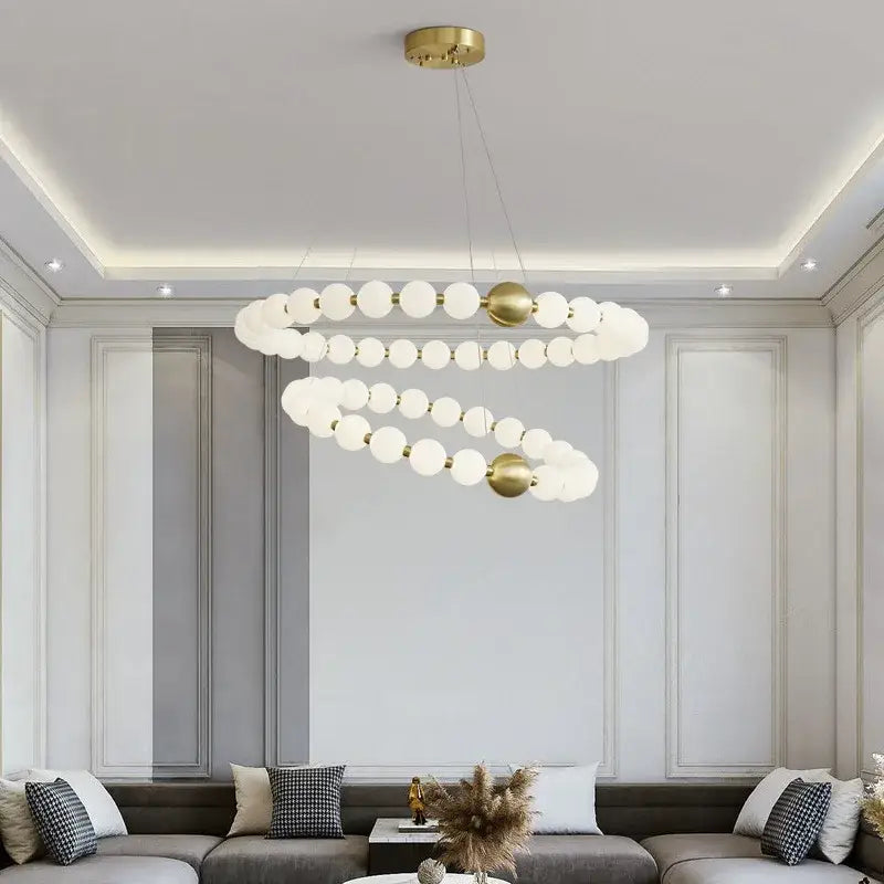 Gold-toned spiral brass led chandelier with frosted acrylic spheres for dining room decorbites brass led lighting