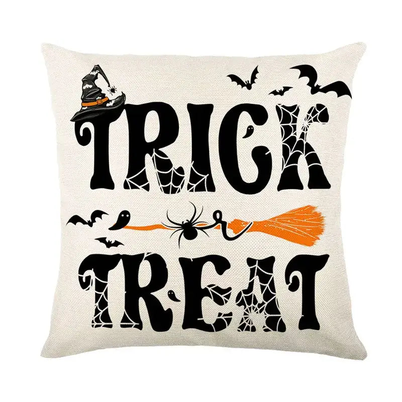 Off-white halloween pumpkin linen cushion cover with black trick or treat lettering and orange broomstick design