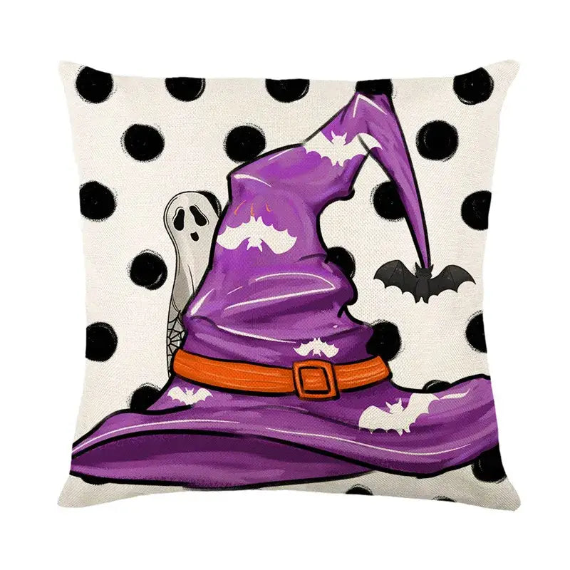 Purple witch hat with orange belt and white bat accents on black and white polka dot halloween pumpkin linen cushion cover