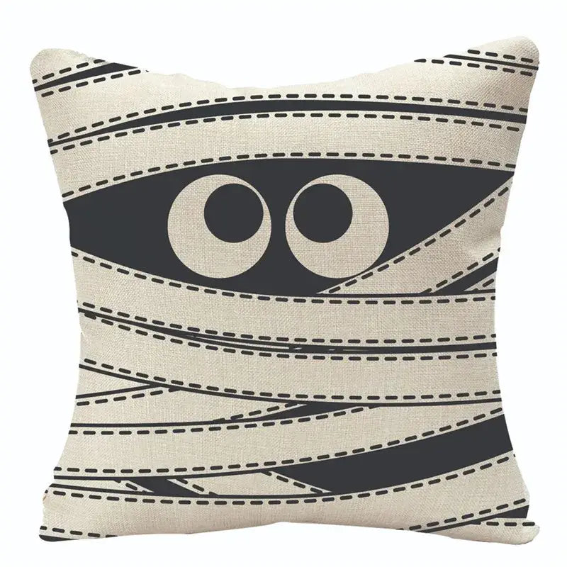 Beige halloween pumpkin linen cushion with black mummy wrap design and cartoon eyes for living room sofa
