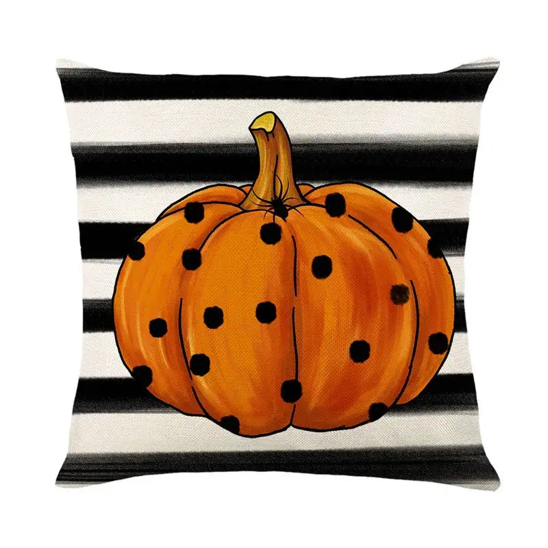 Orange halloween pumpkin linen cushion with black polka dots on black and white striped linen cushion cover
