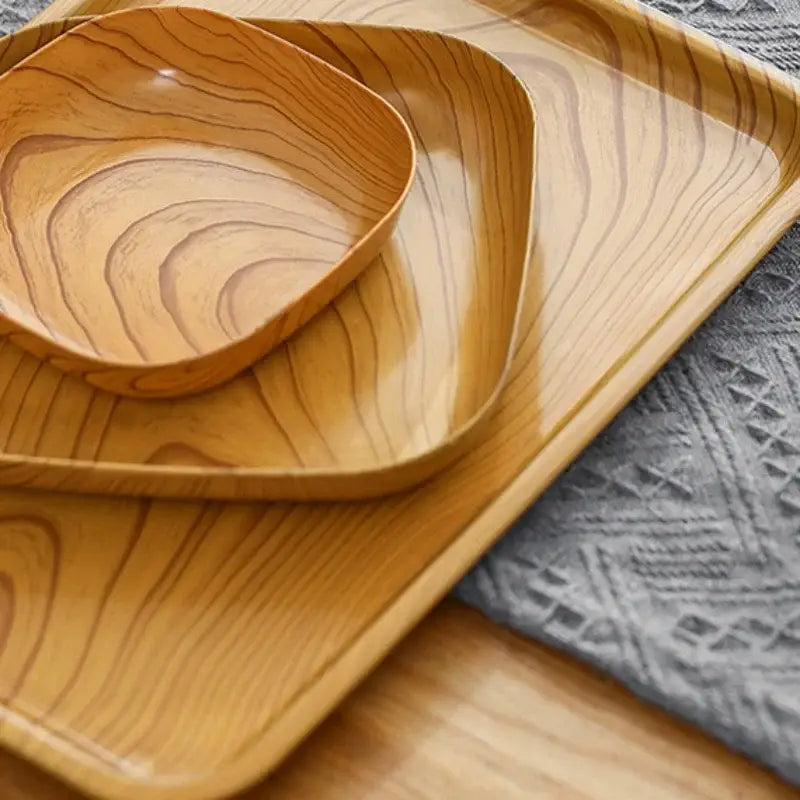 Set of three light wood-grain square imitation wood snack trays with smooth rounded edges and a glossy finish by decorbites