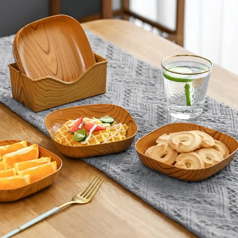Set of square imitation wood snack plates with natural grain finish in matching wooden storage box for dining room use