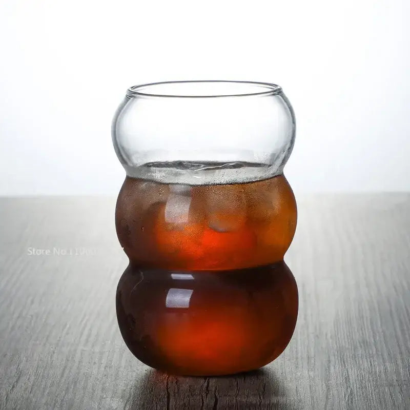 Clear glass cold brew coffee tumbler with unique segmented rounded design and frosted lower section for brew coffee cup