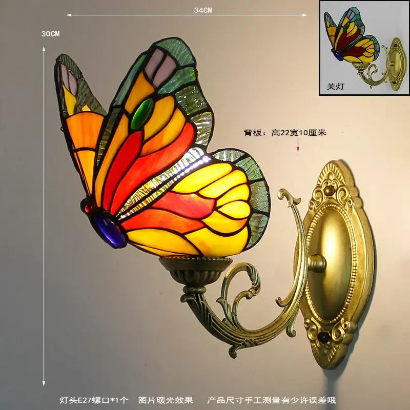 Vibrant stained glass butterfly wall sconce with gold-toned ornate metal mounting and curved arm for living room decorbites butterfly stained wall sconces