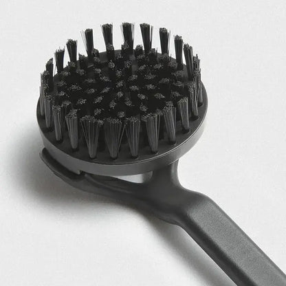 Black plastic coffee maker brush with dense stiff bristles arranged in a circular head for kitchen cleaning tool