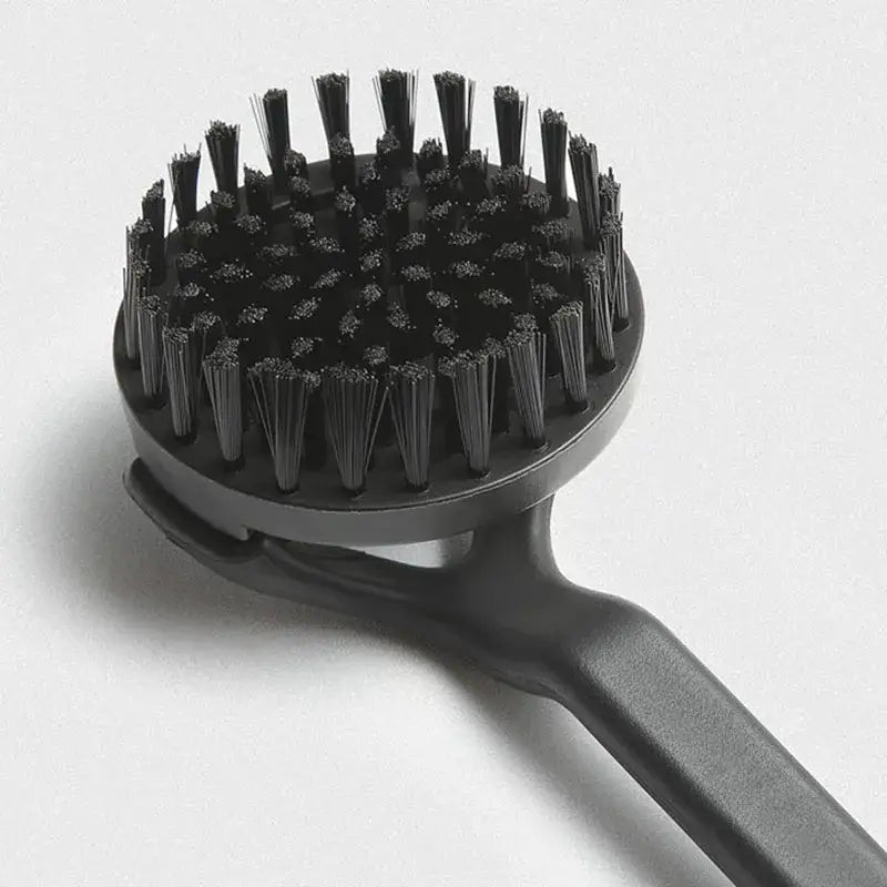 Black plastic coffee maker brush with dense stiff bristles arranged in a circular head for kitchen cleaning tool
