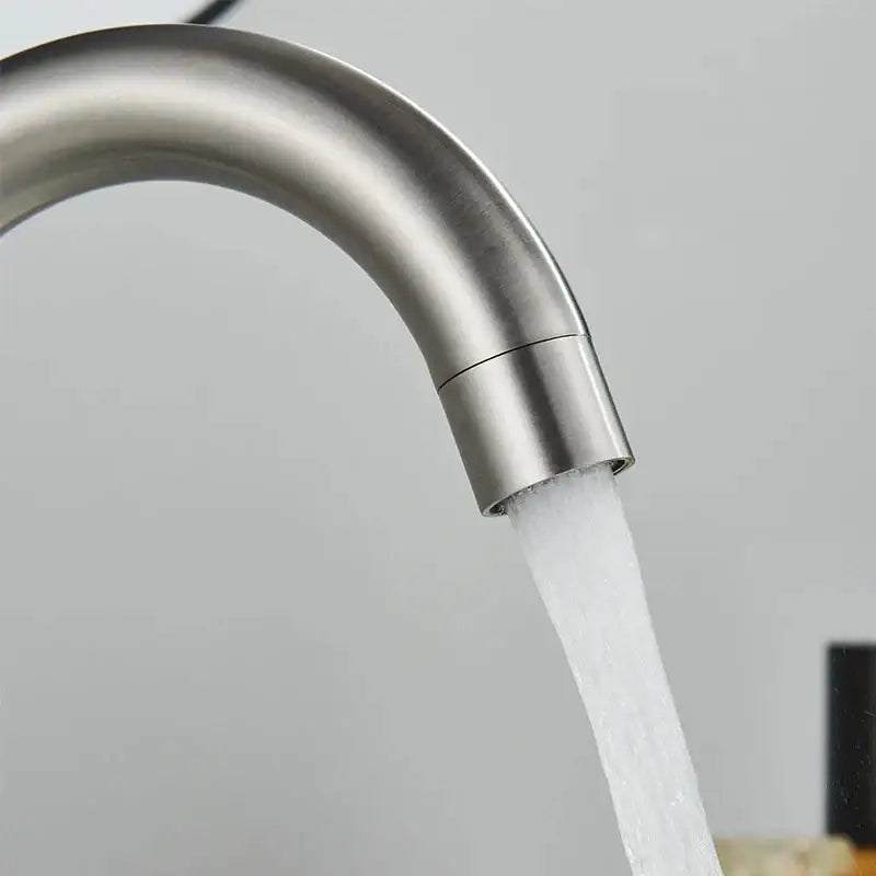 DecorBites 304 stainless steel rotating bathroom sink faucet with sleek brushed finish and curved spout flowing water