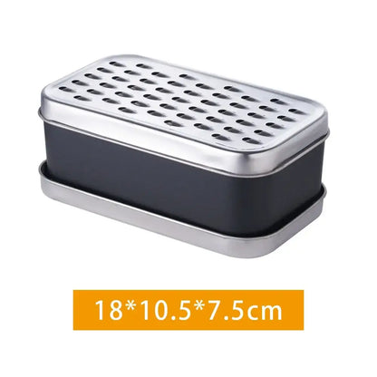 Rectangular stainless steel soap dish with black interior and perforated lid paired with stainless steel cheese grater container lid