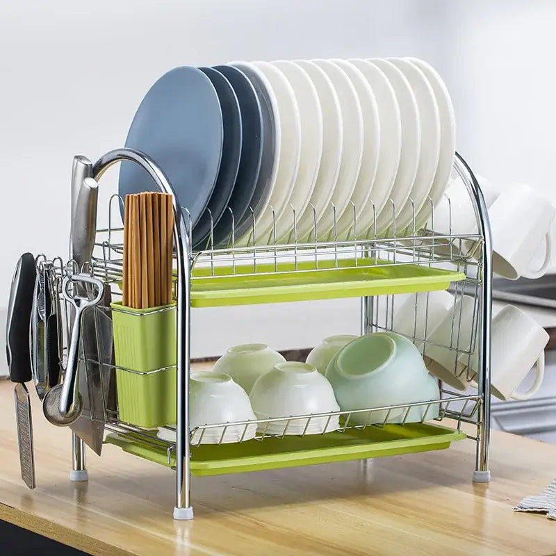 Stainless steel curved kitchen drying rack with lime green trays and utensil holder organized with plates and mugs