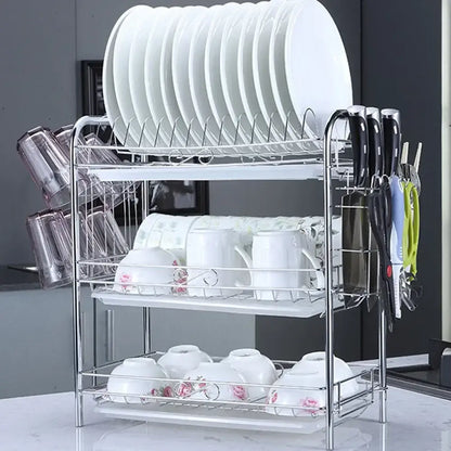 Silver stainless steel curved kitchen drying rack with three-tier white plastic trays and wire mesh dish organizer shelf