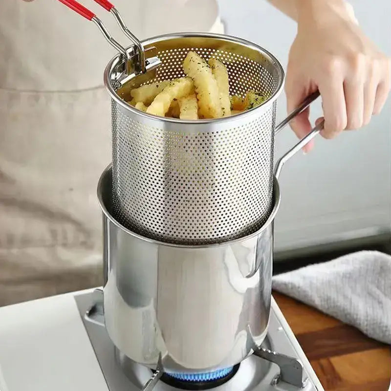 Stainless steel deep fryer pot with perforated basket and red-handled tongs for draining fried food by decorbites deep fryer