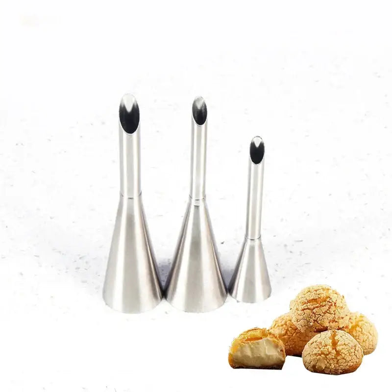 Set of three stainless steel puff cream nozzles with blackened ends displayed with golden dessert puff cream