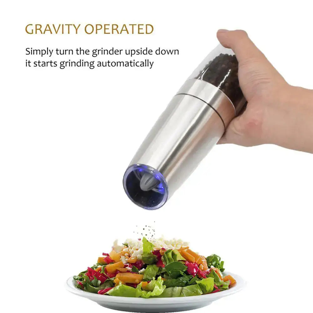 Stainless steel electric spice pepper grinder with blue-tinted base and transparent top for automatic kitchen accessory use
