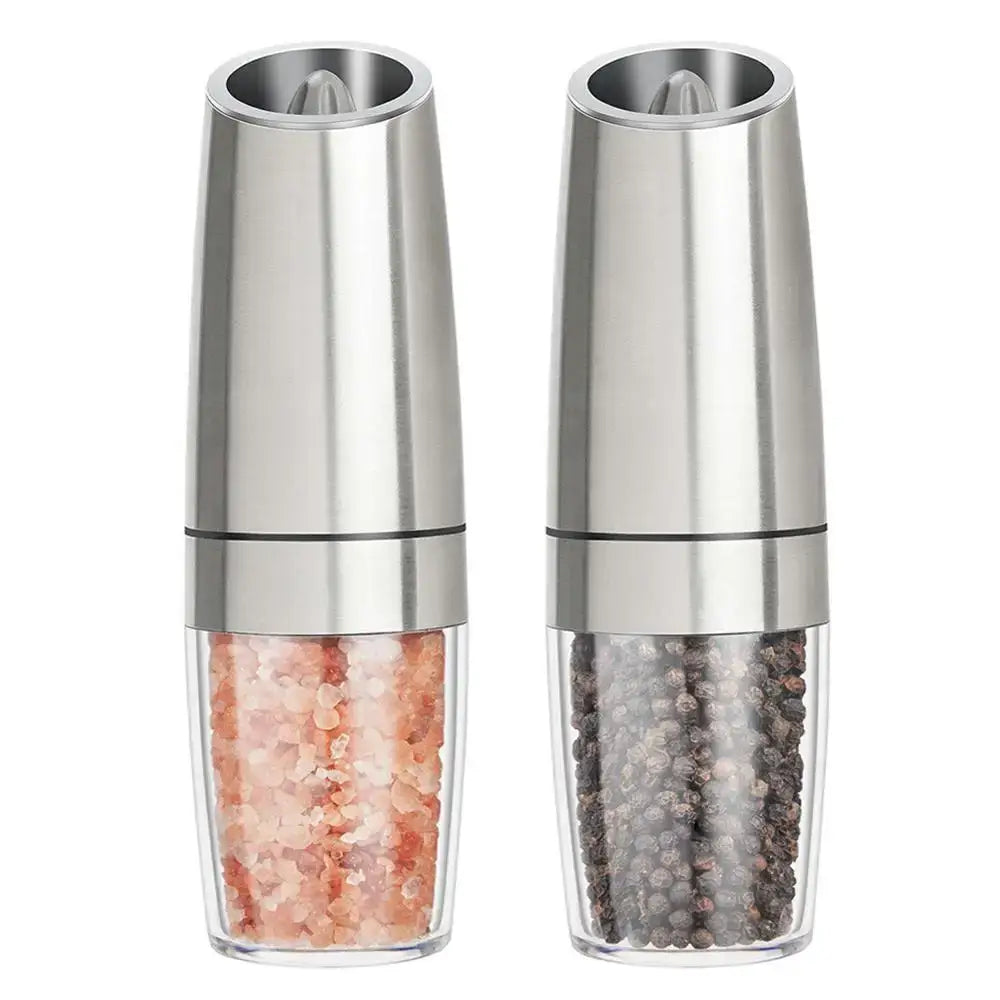 Stainless steel electric pepper grinder set kitchen accessory with clear glass bases containing pink salt and peppercorns