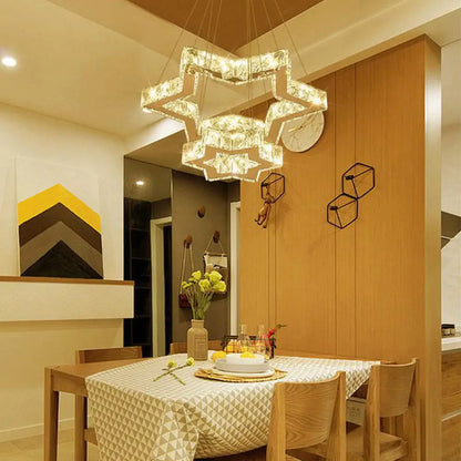 Lámpara de techo LED de acero inoxidable: Lámpara colgante con forma de estrella de cinco puntas y bloques de cristal, disponible en tres colores: cálido, blanco y otros.