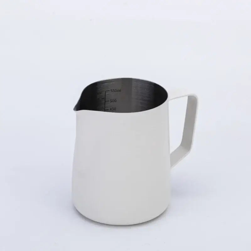 A sleek matte white stainless steel milk frothing jug with measurement markings for precise milk frothing