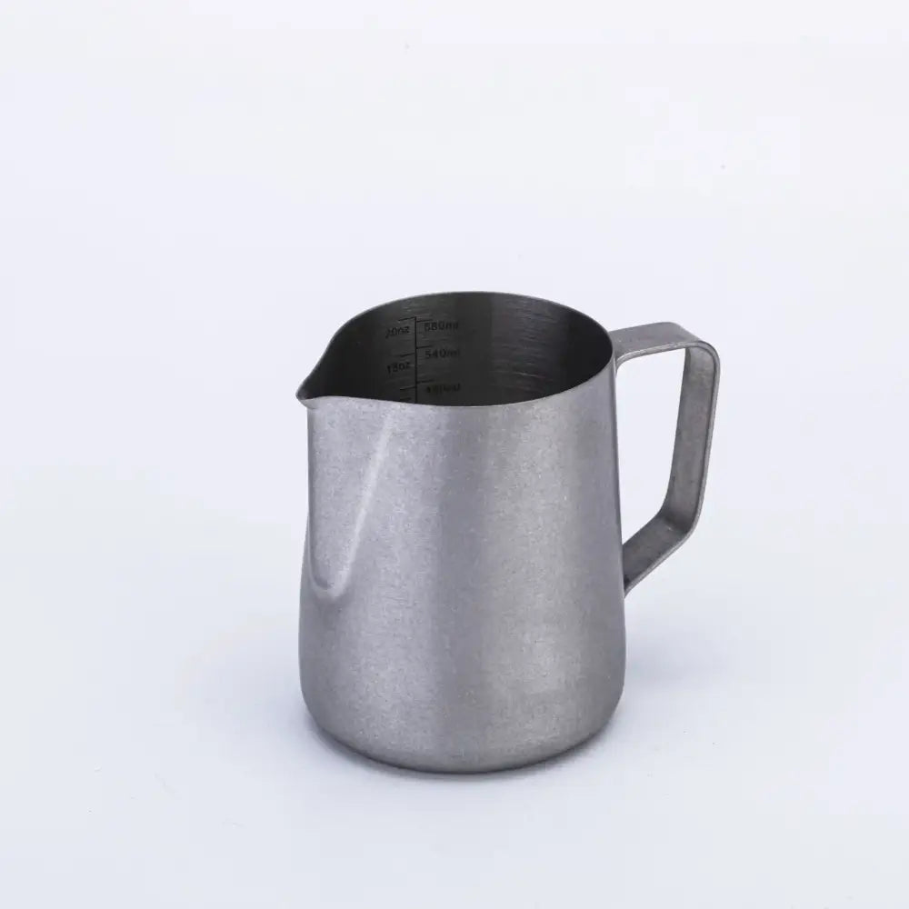 Silver stainless steel milk frothing jug with interior measurement markings for precise milk frothing in the kitchen