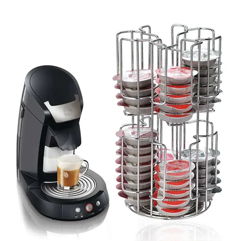 Black and silver nespresso coffee machine with espresso next to stainless steel multi tiered coffee capsules organizer stand
