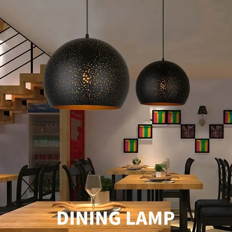 Black spherical pendant light with starry pattern and warm amber lining decorbites black nordic dining chandelier