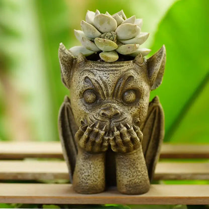 Decorbites gargoyle resin vase sculpture featuring a textured stone-like planter with a pale green succulent