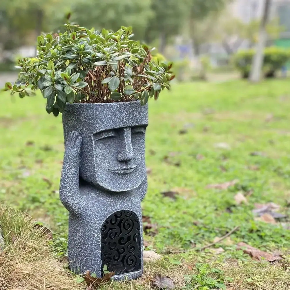 Stone gray easter island statue sculpture garden moai planter made of gray stone with intricate carved details and arched doorway