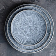 Set of three decorbites ceramic dinner plates in speckled blue and white with concentric ridges and smooth rims