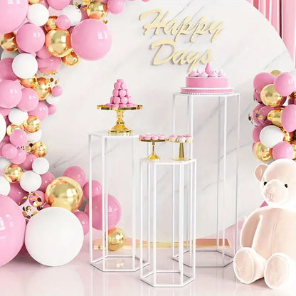 Pink and gold balloon arch with white accents complementing a 6-piece storage rack for home use and vase decoration bottle