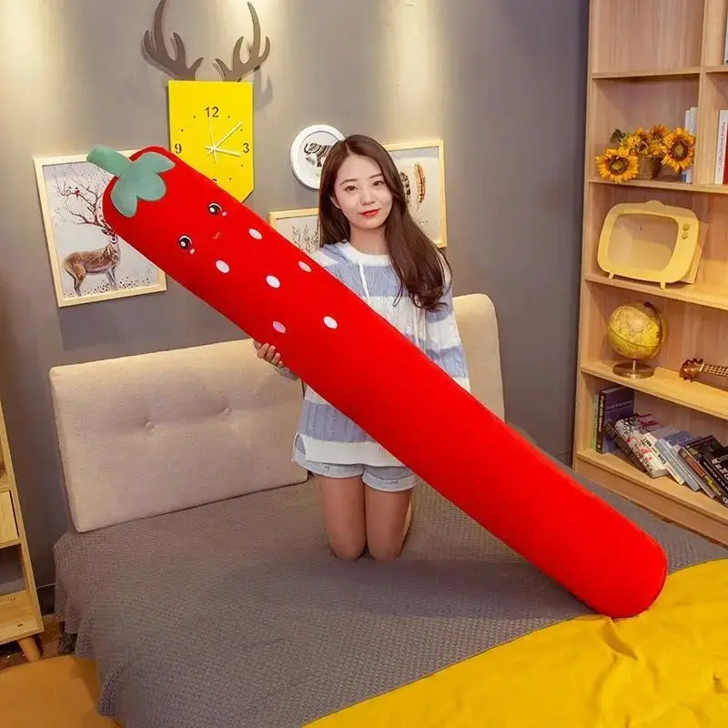 A plush red decorbites cylindrical soft pregnancy sleep strawberry sleeper pillow with white polka dots and green top