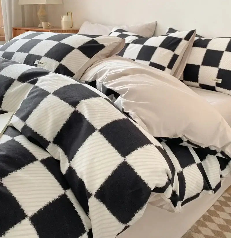 Black and white checkered duvet cover with soft textured knit finish paired with beige and blue fitted sheet bedding set decorbites grid printed