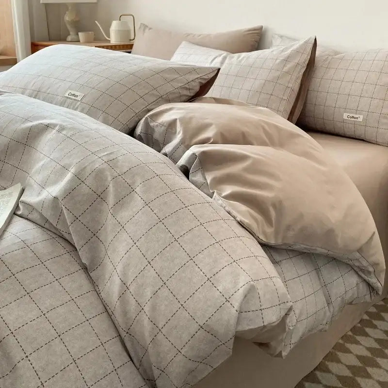 Beige and gray checkered cotton duvet set with subtle stitching details paired with striped beige and blue fitted sheet bedding set decorbites grid printed