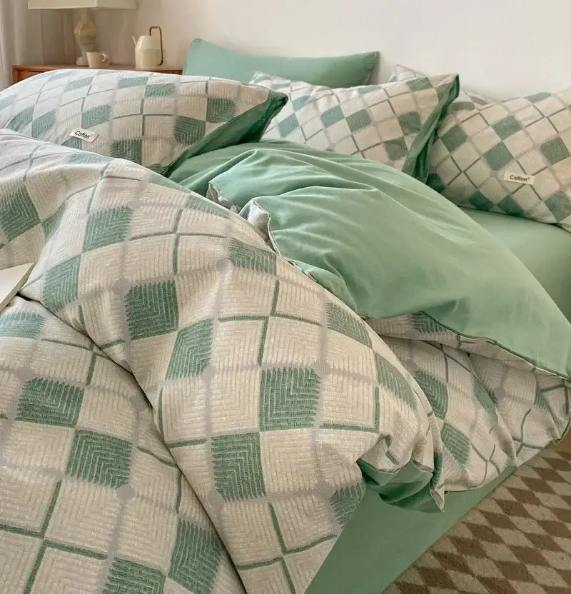 Soft mint green and off-white geometric duvet set with woven texture paired with a striped beige and blue cotton fitted sheet bedding set decorbites grid printed