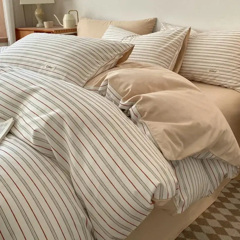 Beige and white striped cotton bedding set with subtle red and gray vertical stripes featuring decorbites grid printed fitted sheet