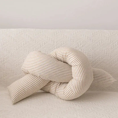 A soft cream-colored decorbites cloud star pillow with beige and white vertical stripes in a star moon shape