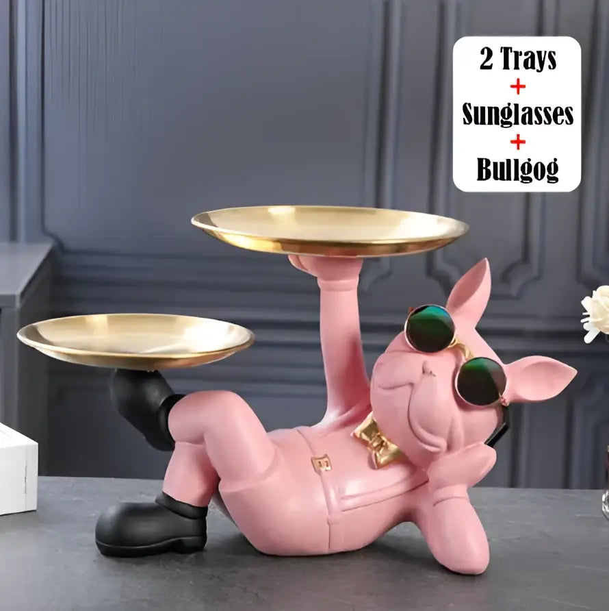 Pink pig figurine with black boots and green sunglasses holding gold trays next to stylish black and gold bulldog figurine sculpture decorbites living room decor