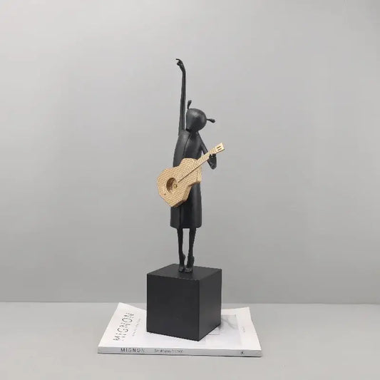Stylized black and gold guitarist resin figure standing on a black base ideal for decorbites guitarist resin decor