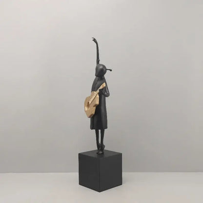 Stylized black and gold guitarist resin figure on cube base ideal for decorbites guitarist resin and resin figure sculptures