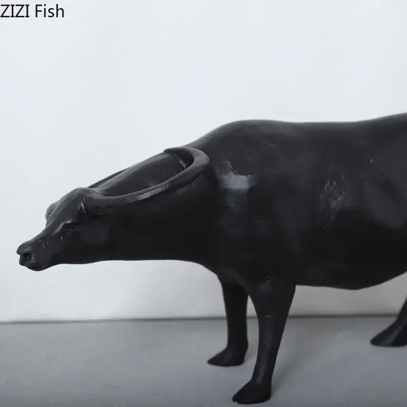 Stylized black matte metal cowherd shepherd boy sculpture with glossy buffalo figurine and detailed horns for living room decorbites cowherd shepherd