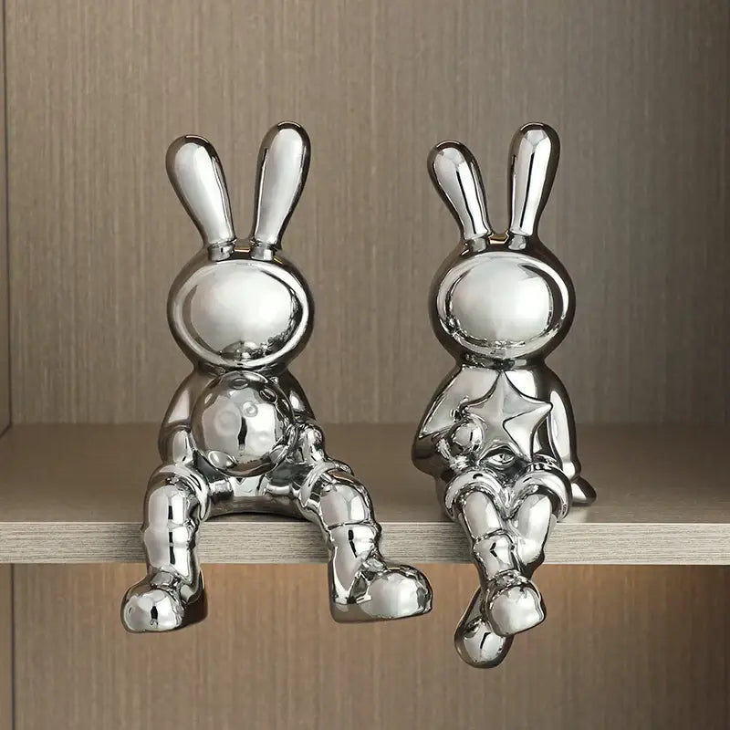 Two chrome-finished ceramic rabbit sculpture set with minimalist design for stylish living room decor