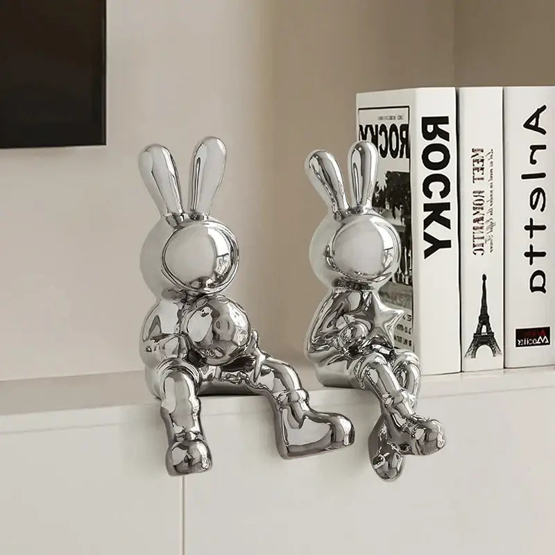 Two sleek chrome ceramic rabbit sculpture set with glossy minimalist design for living room decor