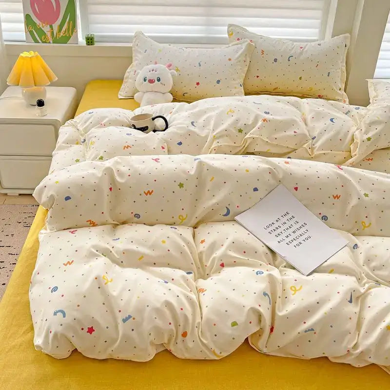 Cream-colored quilted DecorBites summer bedding set with multicolored stars moons and abstract shapes for twin queen sizes