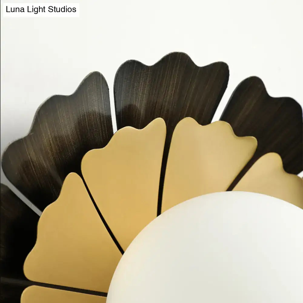 A modern sunflower yellow and wood ceiling light with fan-like panels and a white glass ball in matte white finish