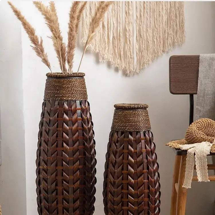 Two tall dark brown bamboo woven vases with herringbone pattern and rope-wrapped necks for living room decor
