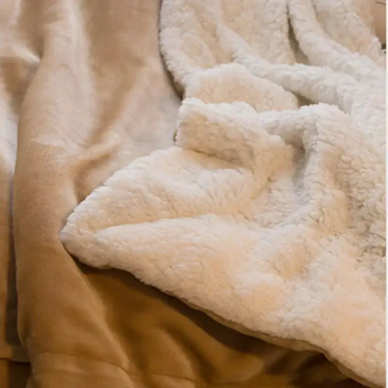 Cream-colored sherpa blanket with plush textured surface and soft fluffy interior from tan and cream cozy lambswool flannel collection