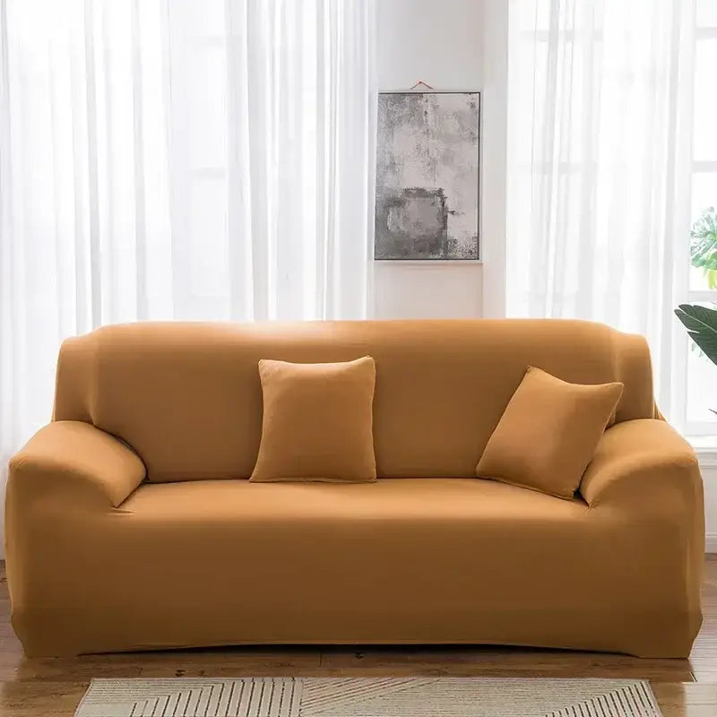 Tan stretchy silk sofa cover with matching pillows in living room setting suitable for sofa and accent chairs