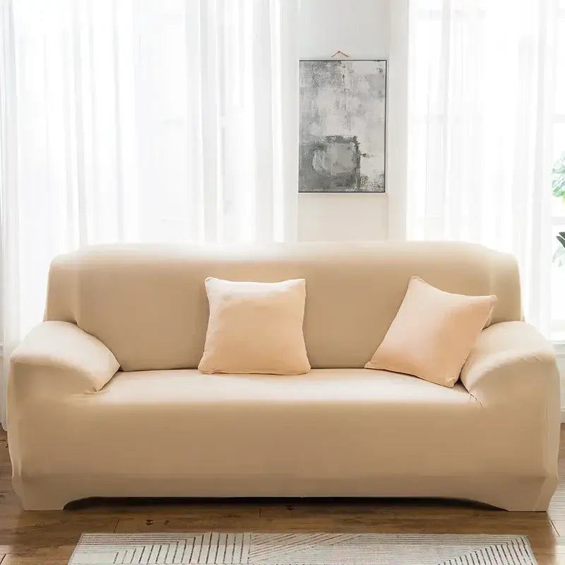 Beige stretchy silk sofa cover with matching pillows for living room use on sofa cover and accent chairs