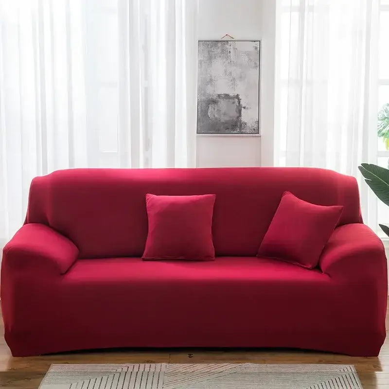 A vibrant red stretchy silk sofa cover with matching pillows fitting a three-seater couch for living room accent chairs
