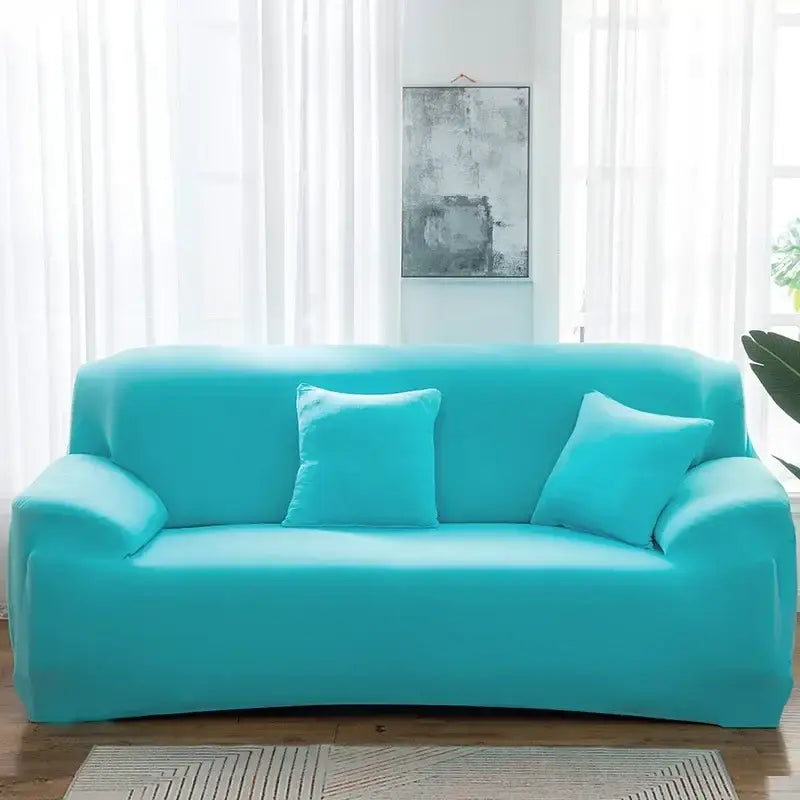 Turquoise silk stretch sofa cover with matching pillows fitted on three-seater couch for living room and accent chairs